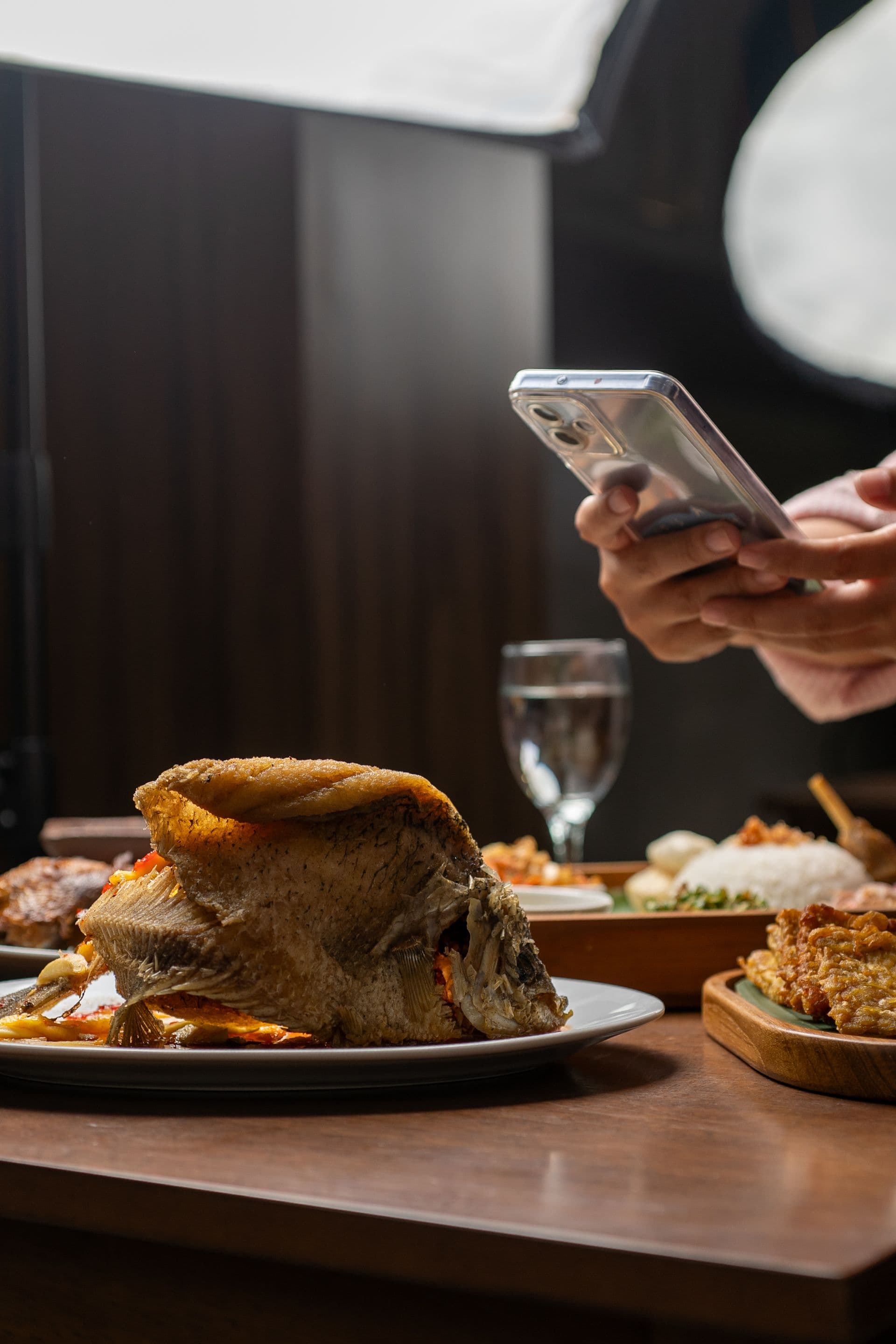 A guest photographing their plated dish before ordering more