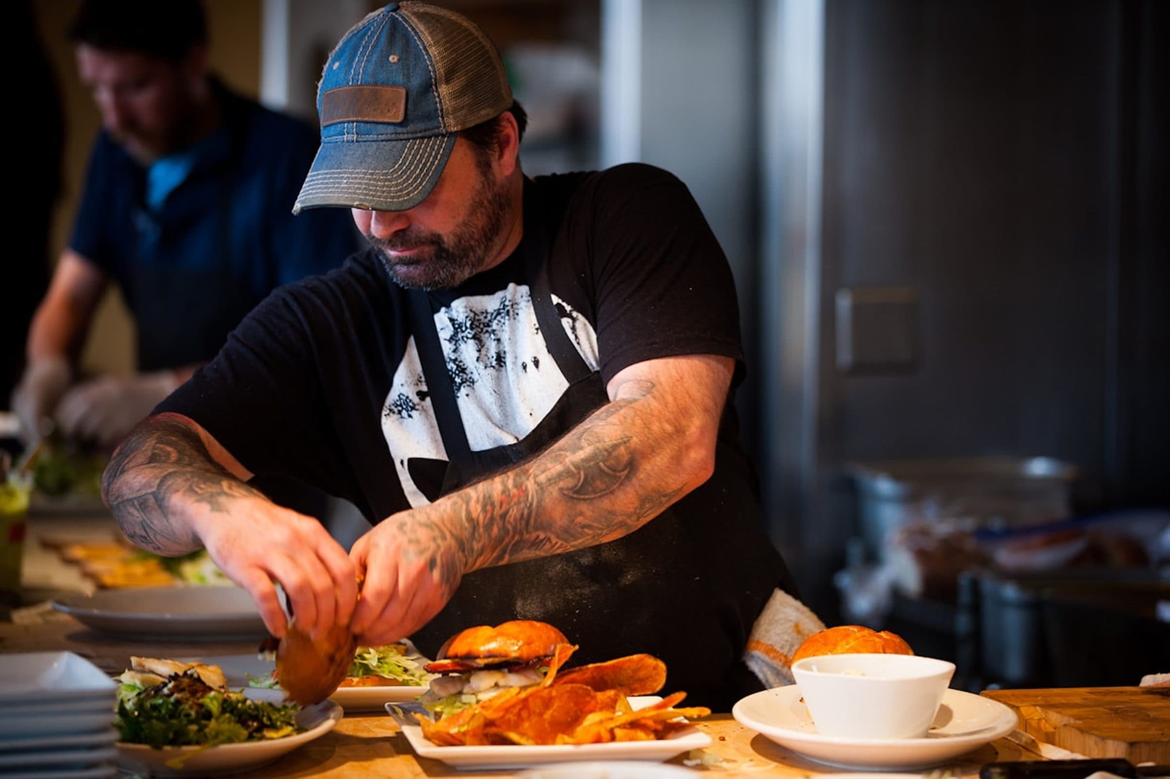 A chef plating dishes during a busy dinner service